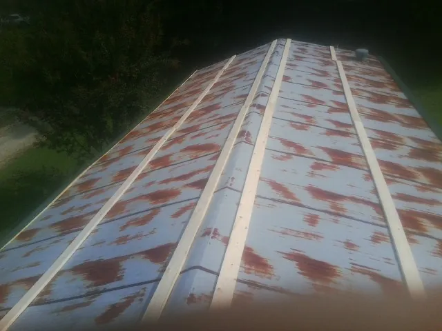 Rusted metal roof panels with new wood purlins before replacement — Storm Damage Roof Repair in Muskego by Roofing Brothers
